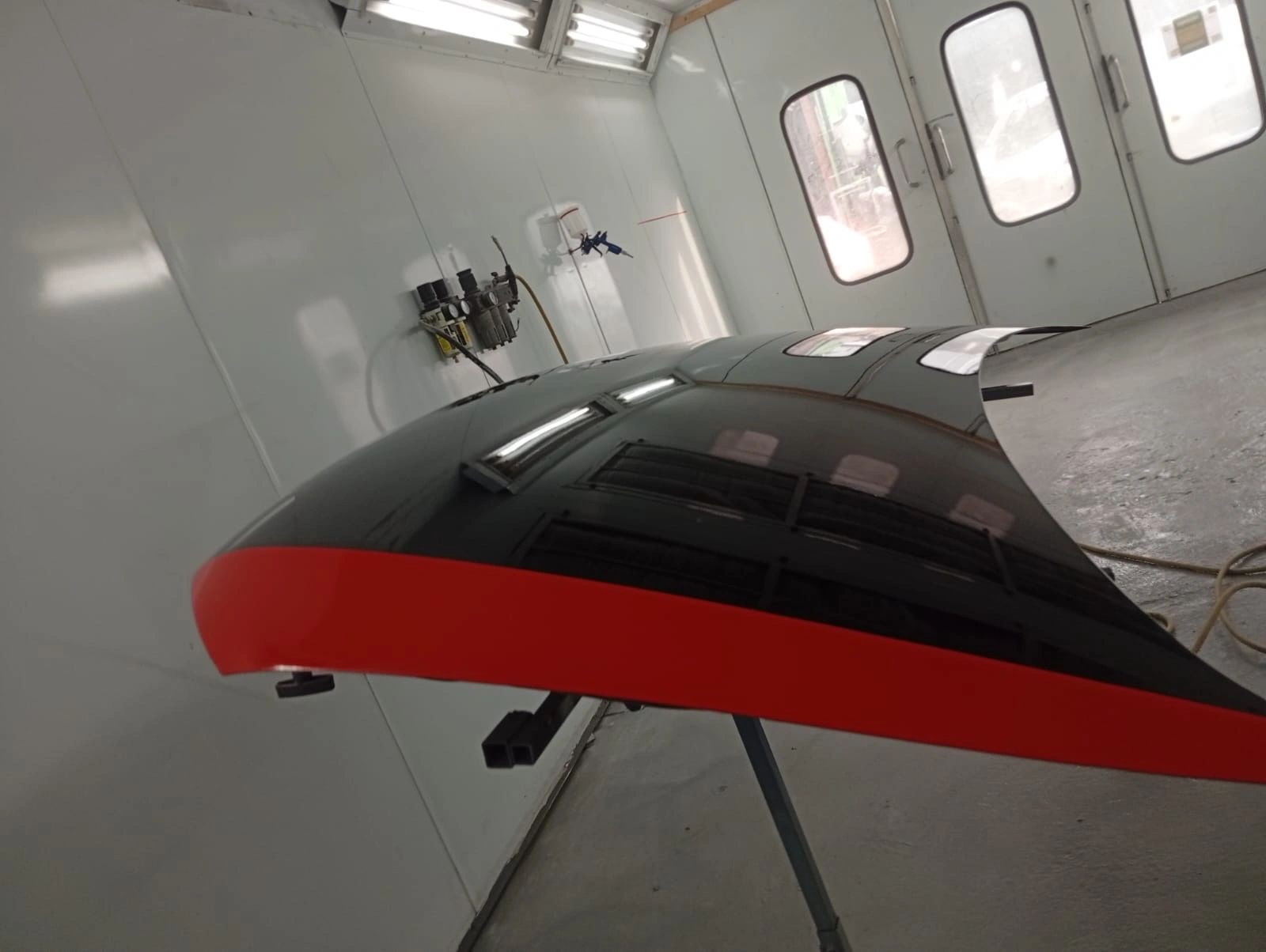 Detailed car gleaming under workshop lighting