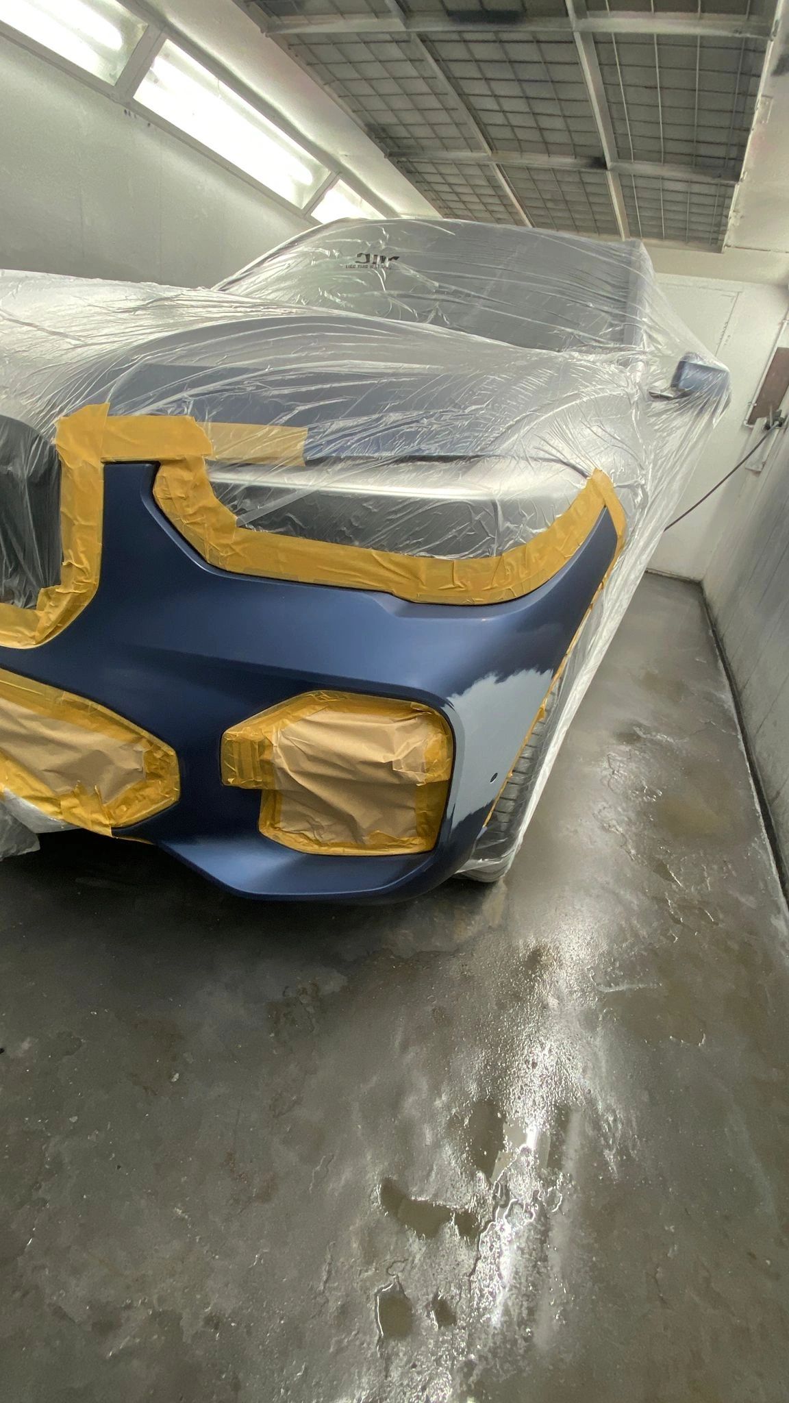 Blue BMW masked at the front