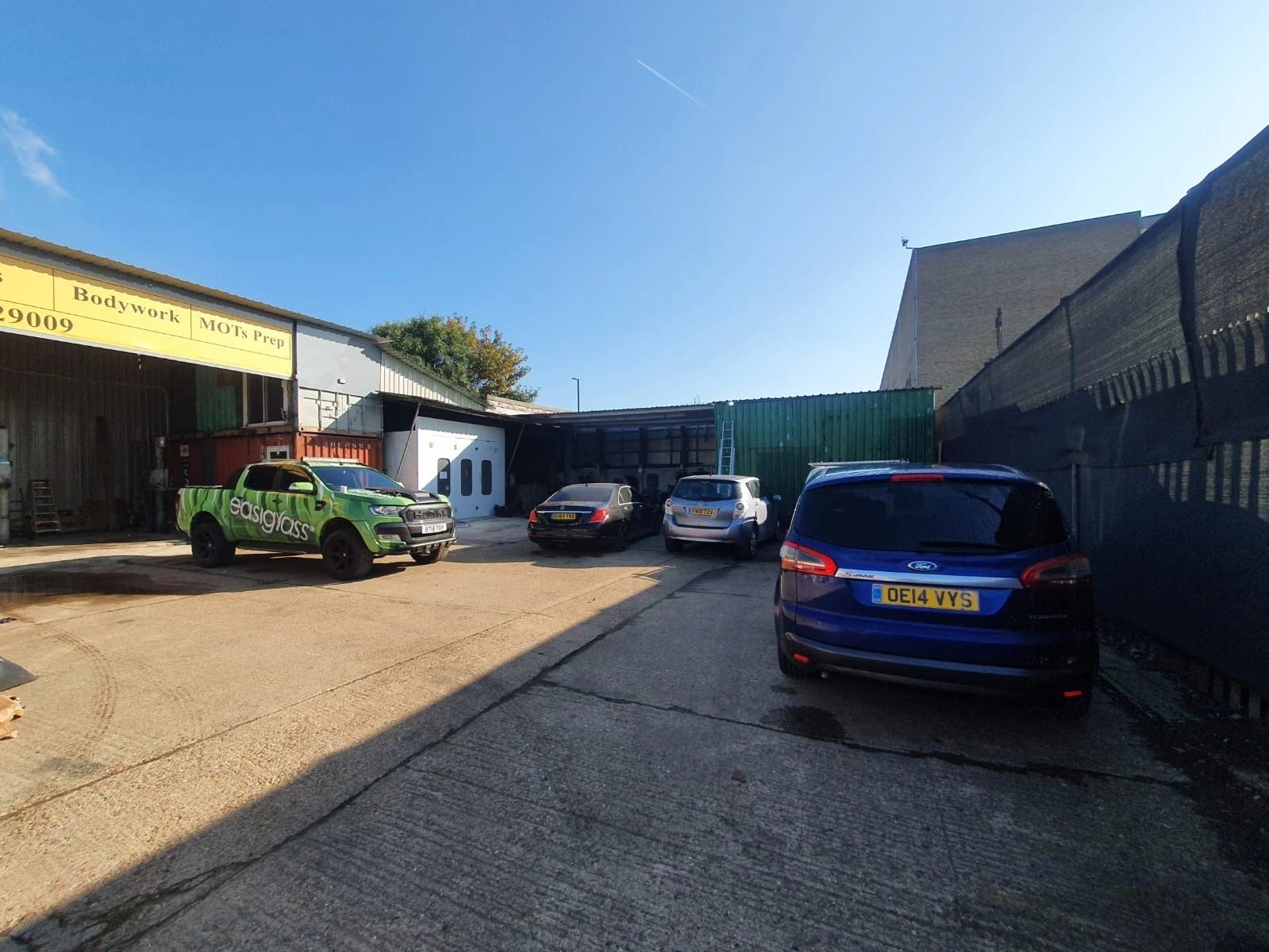 The Same Day Car Paint shopfront and yard in Tottenham Hale on a sunny day